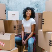 student surrounded by moving boxes